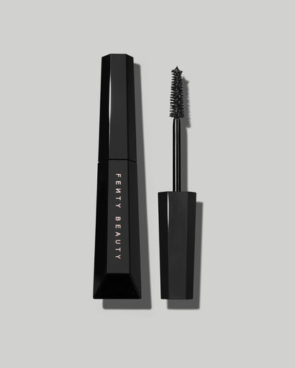 An open Fenty Hella Thicc mascara tube on a grey background.