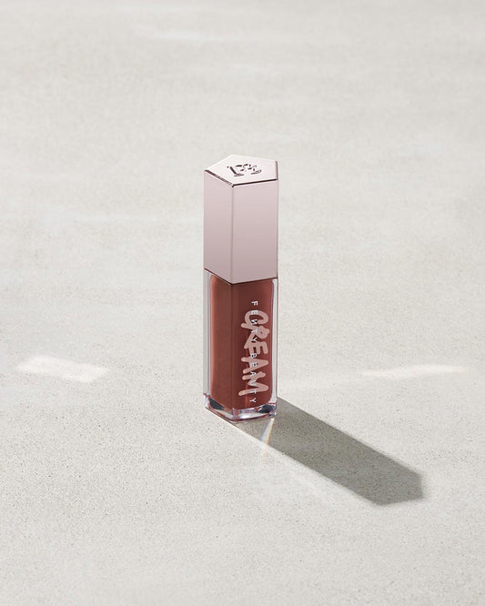 tube of Fenty Beauty Gloss Bomb Cream Color Drip Lip Cream lip gloss shown in shade Cookie Jar