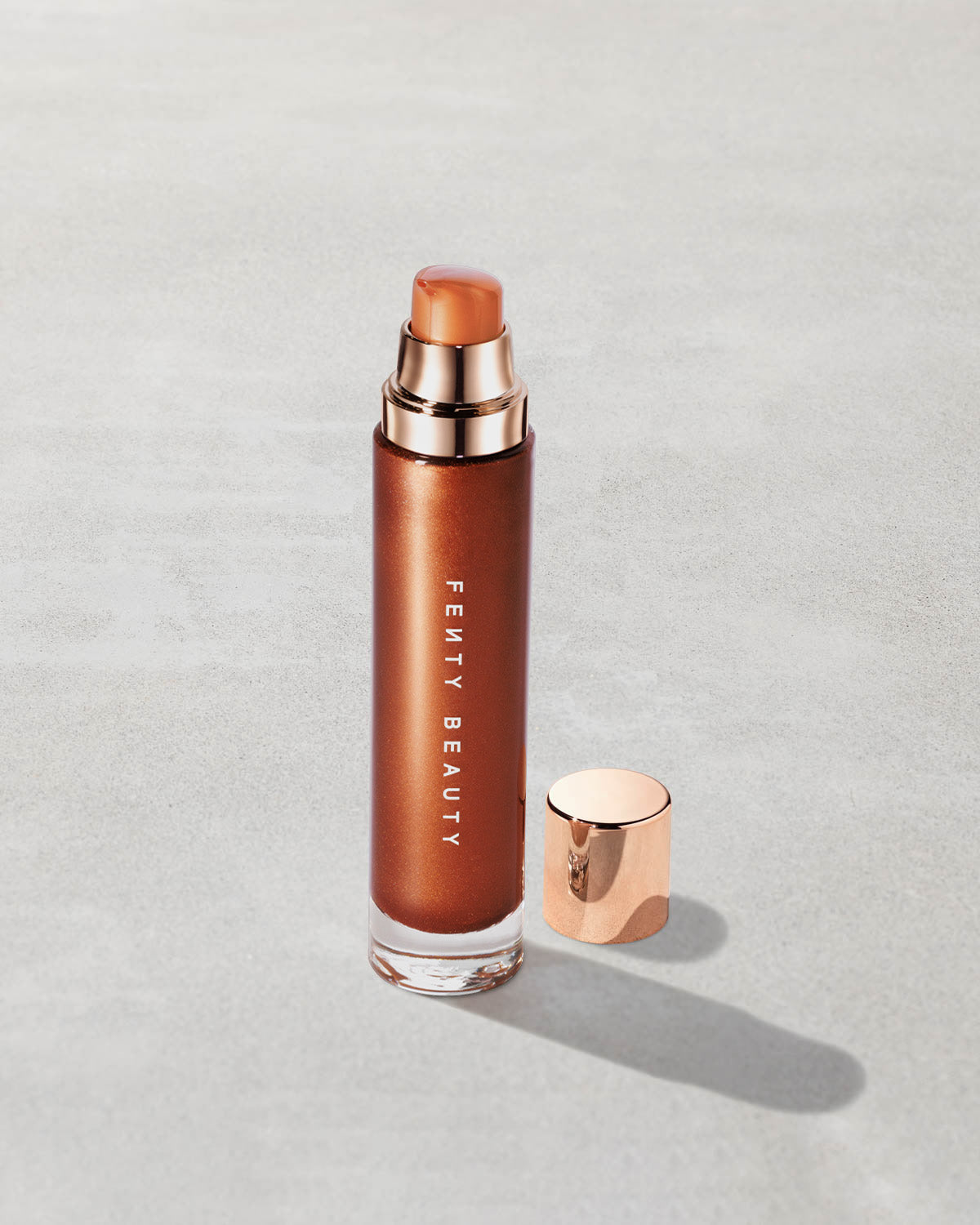 Open product shot of Body Lava Body Luminizer in shade 'Penny Drop'.